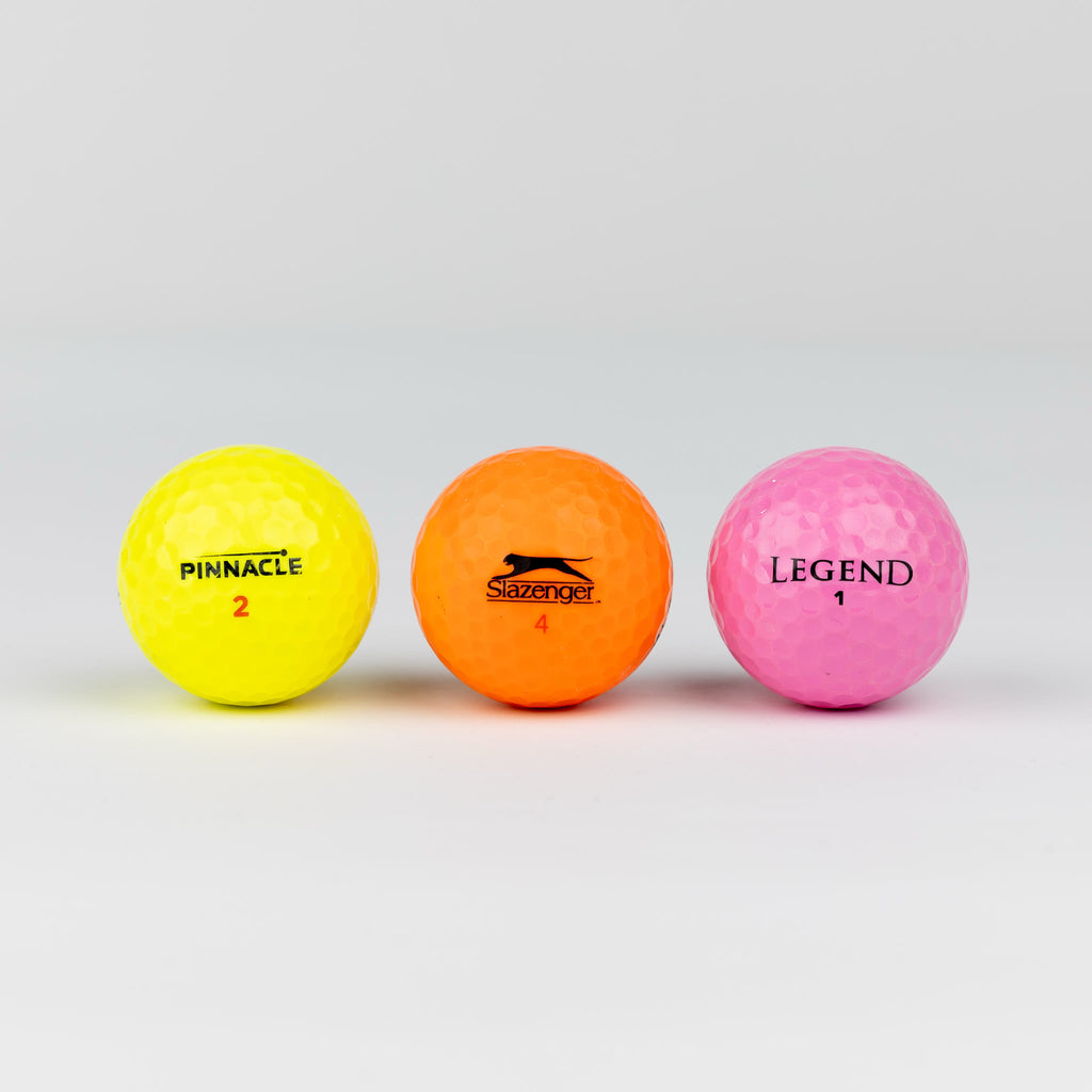 Colored golf balls (pink, orange, yellow)