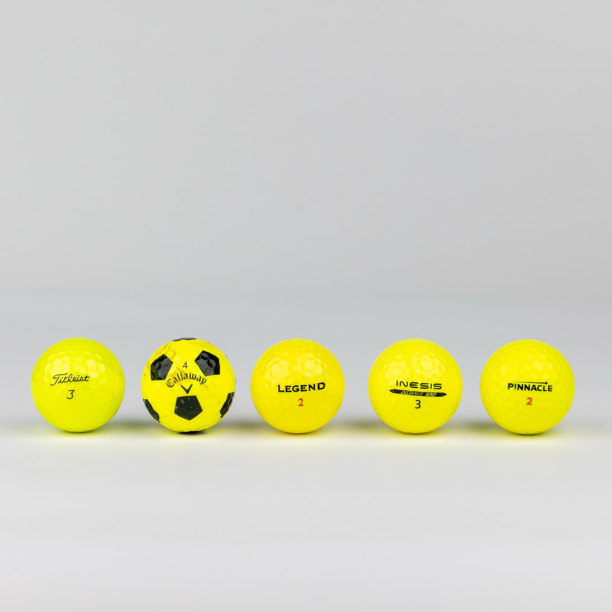 Colored golf balls (pink, orange, yellow)