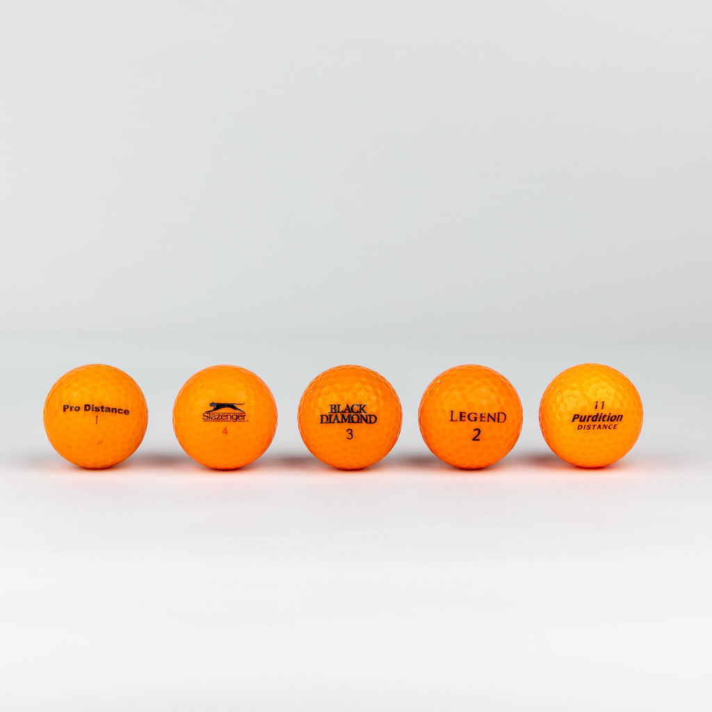 Colored golf balls (pink, orange, yellow)