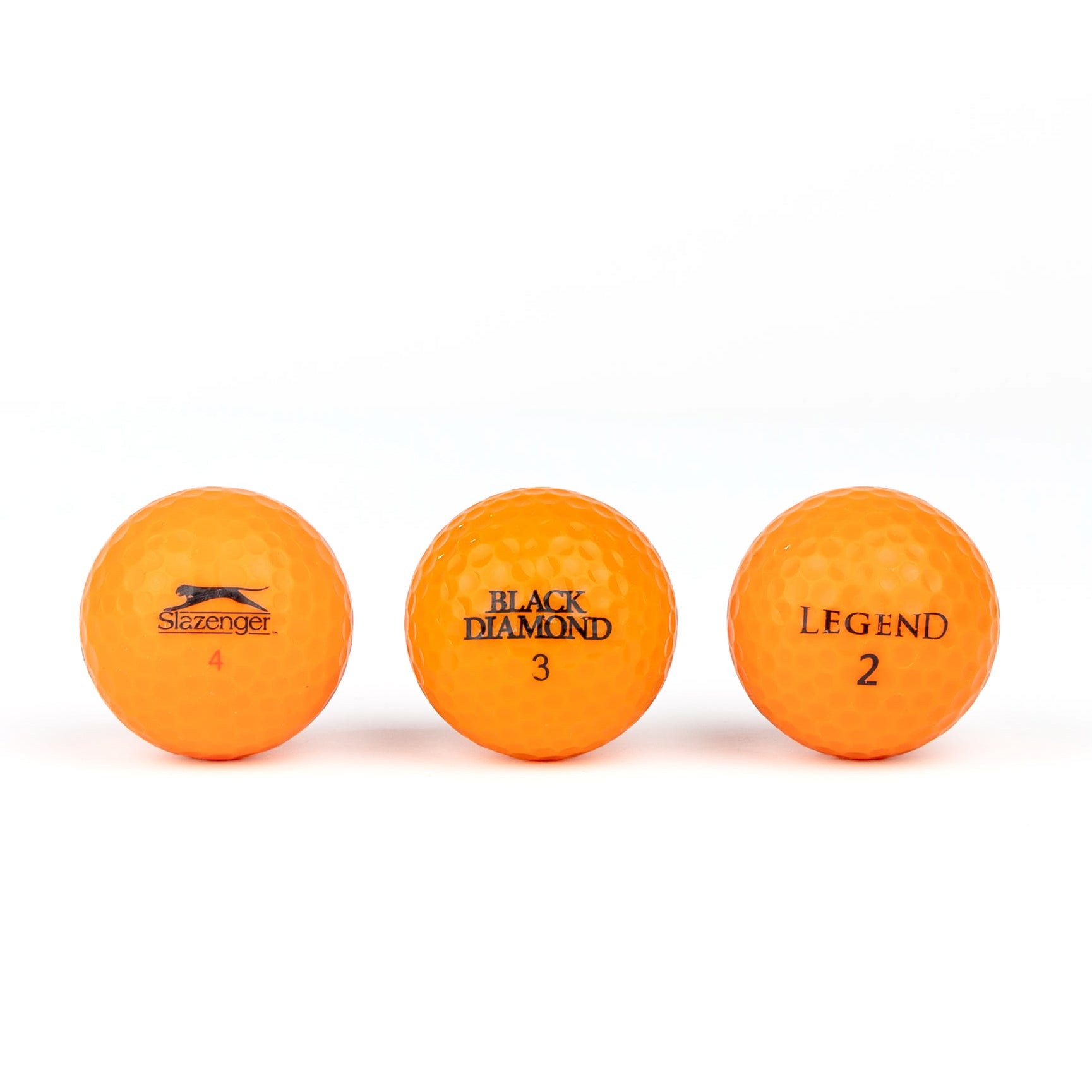 Colored golf balls (pink, orange, yellow)