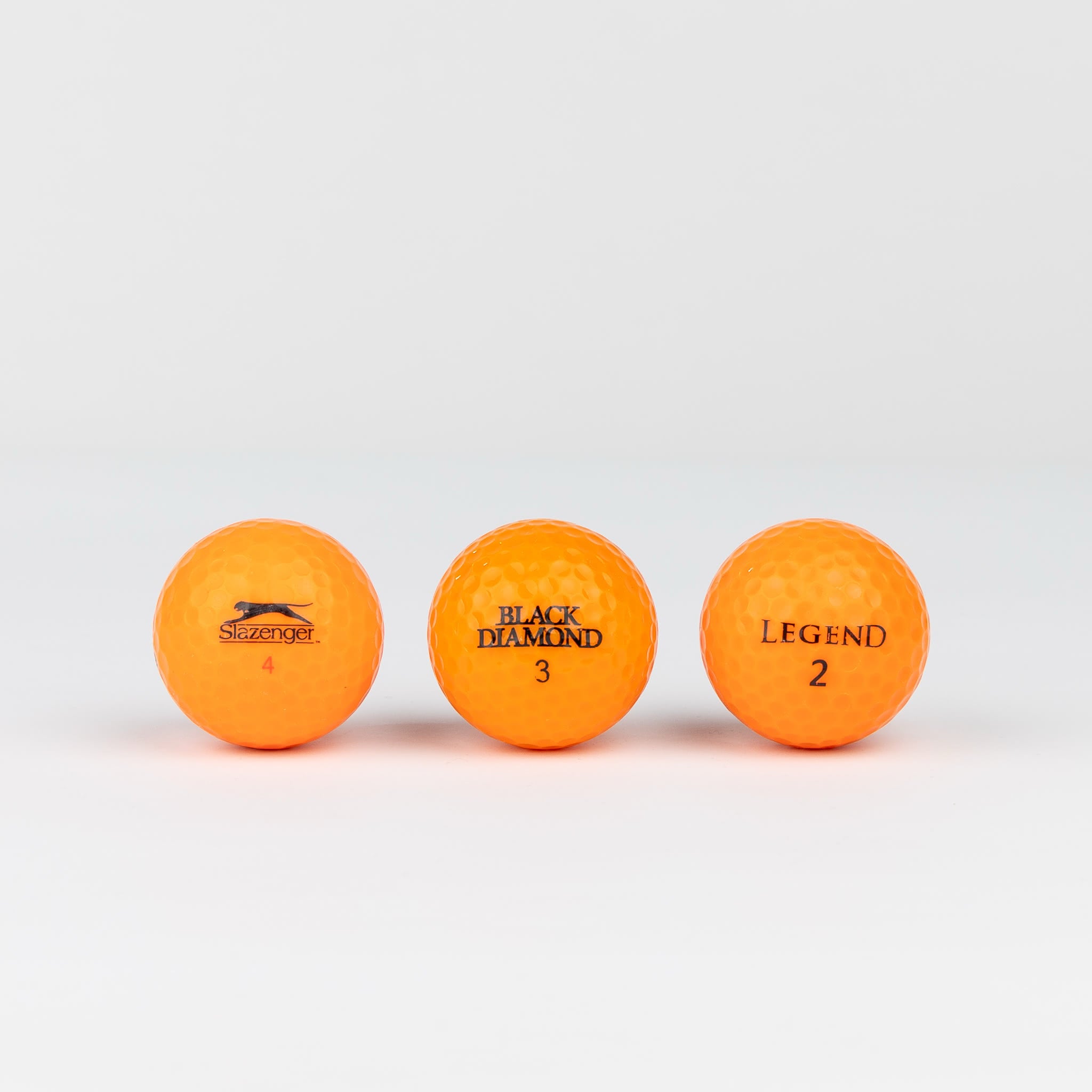 Colored golf balls (pink, orange, yellow)